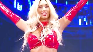 WWE - Carmella in red outfit standing over Sasha Banks