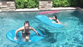 Two Bikini Teens challenging each other in pool