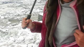 Angel Fowler Walks with Umbrella in Snow next to River