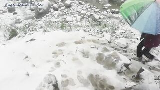 Angel Fowler Walks with Umbrella in Snow next to River