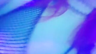 girl dances to loud club music wearing only a mesh top