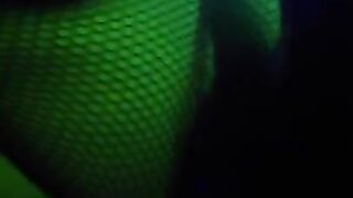 girl dances to loud club music wearing only a mesh top