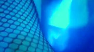 girl dances to loud club music wearing only a mesh top