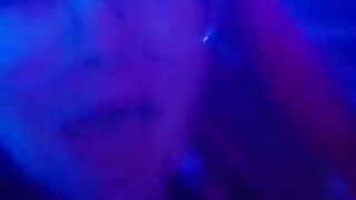 girl dances to loud club music wearing only a mesh top