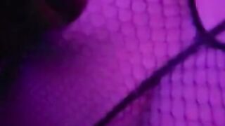 girl dances to loud club music wearing only a mesh top