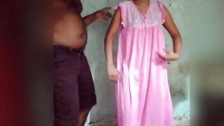 The wife, dressed in a nightgown, performs a sexy dance with husband