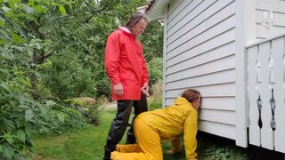 Pissing on MILF in full rainwear and rubber boots in the garden