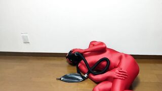 Respiratory control with gas mask on red zentai