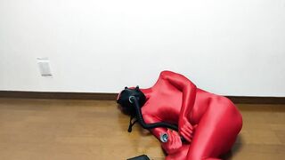 Respiratory control with gas mask on red zentai