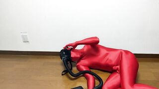 Respiratory control with gas mask on red zentai