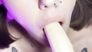 Lucky banana in the mouth of a girl with braces. Eye contact