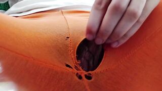 Indian girl working from home with hole in her pants. Under table view.