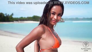 Putri Cinta stripping on a beautiful tropical beach