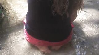 Country Girl Crawling On Her Hands and Knees In Water At Popular Spring Creek