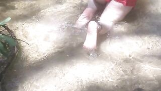 Country Girl Crawling On Her Hands and Knees In Water At Popular Spring Creek