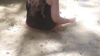 Country Girl Crawling On Her Hands and Knees In Water At Popular Spring Creek