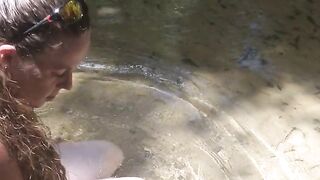 Country Girl Crawling On Her Hands and Knees In Water At Popular Spring Creek