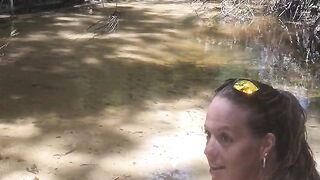 Country Girl Crawling On Her Hands and Knees In Water At Popular Spring Creek