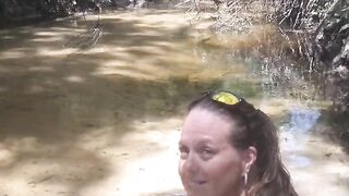 Country Girl Crawling On Her Hands and Knees In Water At Popular Spring Creek