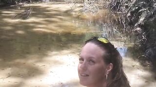 Country Girl Crawling On Her Hands and Knees In Water At Popular Spring Creek