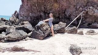 Hot mom in transparent t-shirt on the beach at low tide