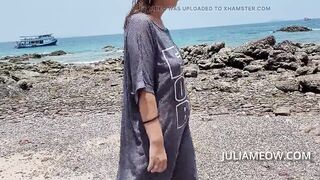 Hot mom in transparent t-shirt on the beach at low tide